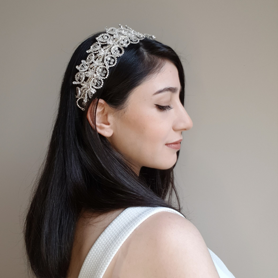 A bride wearing a bridal headpiece with Swarovski stones and pearls.