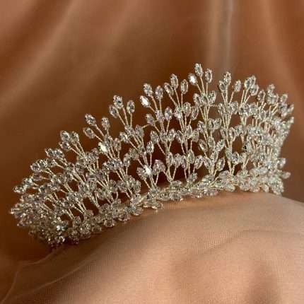 “Side view of a silver bridal tiara with marquise-cut CZ crystals in a leaf-branch design.”