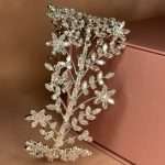 Side view of a floral bridal headband with marquise and round CZ crystals on a silver vine.