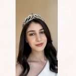 Model wearing a silver bridal tiara with emerald green pear crystals and clear Swarovski & CZ stones in pear and round shapes.