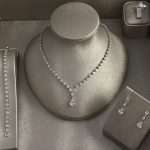 Rhodium-plated CZ pear-drop bridal jewelry set with necklace, earrings, bracelet and ring.