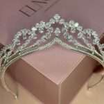 Front view of a Princess Rajwa–inspired bridal tiara (same crown design worn by Princess Rajwa, wife of Crown Prince Hussein of Jordan), set with Swarovski and CZ pear- and round-cut crystals on a blush pink Elnoria box.