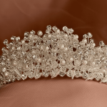 Close-up of a pearl and Swarovski clear crystal bridal tiara crown with clustered crystals and pearls