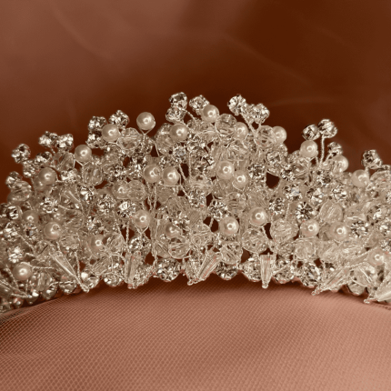 Close-up of a pearl and Swarovski clear crystal bridal tiara crown with clustered crystals and pearls