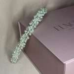 Pearl and clear crystal bridal headband displayed on blush pink Elnoria gift box