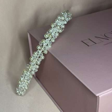 Pearl and clear crystal bridal headband displayed on blush pink Elnoria gift box