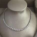 Rhodium-plated cubic zirconia tennis necklace with round-cut stones, displayed on a jewelry bust.