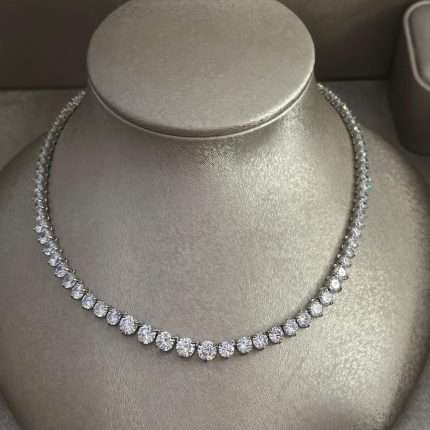Rhodium-plated cubic zirconia tennis necklace with round-cut stones, displayed on a jewelry bust.