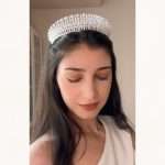 Model wearing the Moonlit Pearl Tiara, a pearl and cubic zirconia bridal crown with pear, marquise, and round stones.