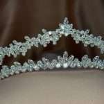 Crystal Whisper Tiara close-up showing marquise and round cubic zirconia stones, silver bridal tiara jewellery with leaf-vine design on soft tulle.