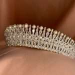 Side view of the Moonlit Pearl Tiara featuring pearls and cubic zirconia stones in pear, marquise, and round shapes on soft tulle.