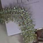 Angled view of the Bronze Bloom Tiara featuring clear and bronze Swarovski crystals in a gold-tone setting.