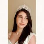 Woman wearing the Crystal Snowflake Tiara, a Swarovski and CZ bridal crown with marquise and round crystals and filigree scrollwork.