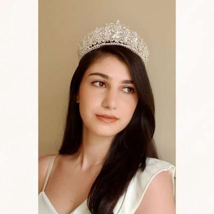 Woman wearing the Crystal Snowflake Tiara, a Swarovski and CZ bridal crown with marquise and round crystals and filigree scrollwork.