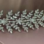 Front close-up of crystal leaf garland headband with cubic zirconia stones, silver tone
