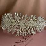 Front view of silver bridal headband with pearls, clear crystals, and marquise & round CZ stones in a floral vine design