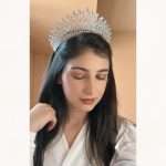 Bride wearing the Crystal Rainfall Crown CZ tiara with cascading pear, marquise, round and radiant-cut stones.