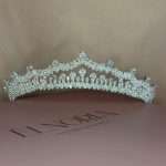 Front view of Swarovski crystal bridal tiara crown with pear, marquise, and round stones on Elnoria box