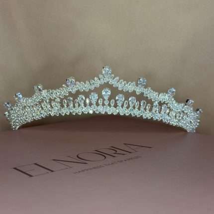 Front view of Swarovski crystal bridal tiara crown with pear, marquise, and round stones on Elnoria box