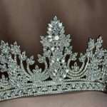 Close-up of a silver bridal tiara crown with Swarovski and CZ crystals in marquise, pear, and round shapes.