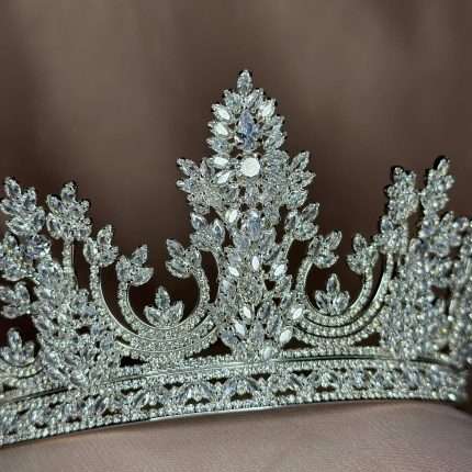 Close-up of a silver bridal tiara crown with Swarovski and CZ crystals in marquise, pear, and round shapes.