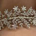 Close-up of a floral bridal headband with marquise and round CZ crystals in a silver vine design.