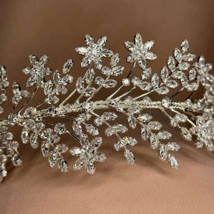 Close-up of a floral bridal headband with marquise and round CZ crystals in a silver vine design.