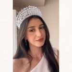 “Model wearing a silver marquise-cut CZ crystal leaf bridal tiara crown.”
