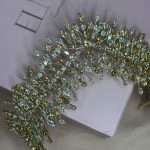 Top view of the Bronze Bloom Tiara with clear and bronze Swarovski crystals in a gold-tone starburst design.