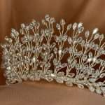 “Detail view of a silver bridal tiara with marquise-cut CZ crystals arranged as sparkling leaf branches.”