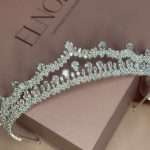 Close-up of luxury Swarovski crystal bridal tiara with pear, marquise, and round stones on Elnoria box
