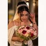 Bride wearing pearl and clear crystal bridal headband with veil, elegant wedding updo hairstyle