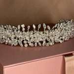 Close-up of pearl and clear crystal bridal headband on silver vine wedding hair accessory
