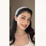Model wearing a floral pearl and clear crystal bridal headband.
