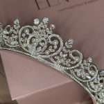 Close-up of the Princess Luster Pearl Bridal Tiara featuring Swarovski crystals, CZ sparkle, pearl accents, and elegant silver scrollwork.