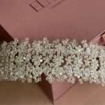 Close-up of a sparkling crystal blossom headband with cubic zirconia flowers and clear crystal beads.