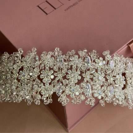 Close-up of a sparkling crystal blossom headband with cubic zirconia flowers and clear crystal beads.