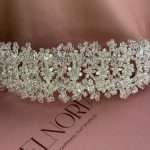 Front view of a sparkling crystal blossom headband with cubic zirconia flowers and clear crystal bead details.