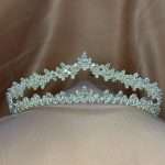 Crystal Whisper Tiara with marquise and round cubic zirconia stones, silver bridal crown on soft tulle with a warm neutral background.