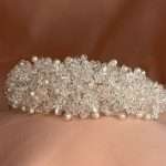Front view of a CZ pearl and clear crystal bridal headband with clustered sparkle detail
