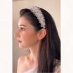 Bride wearing the Crystal Cloud Bridal Headband, a silver crystal and cubic zirconia wedding headband, side view