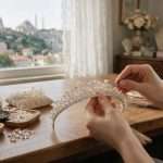 Designer’s hands setting pearls and crystals into a bridal tiara at an Istanbul atelier workbench