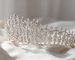 An Elnoria silver floral bridal tiara in profile, built as a continuous run of crystal blooms with no single tall centre.